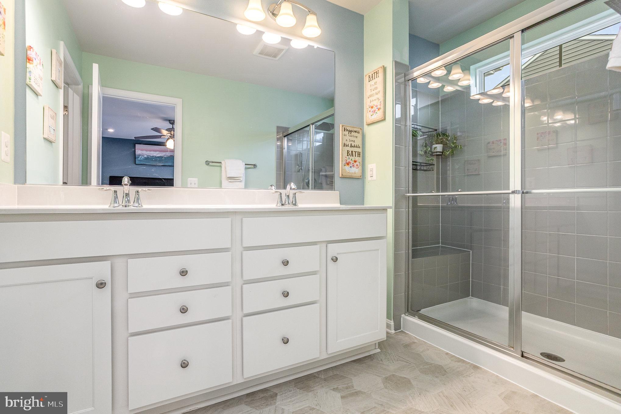 18236 Summit Pointe Drive Triangle, VA 22172 - Photo 25 of 36 a bathroom with a shower sink and mirror
