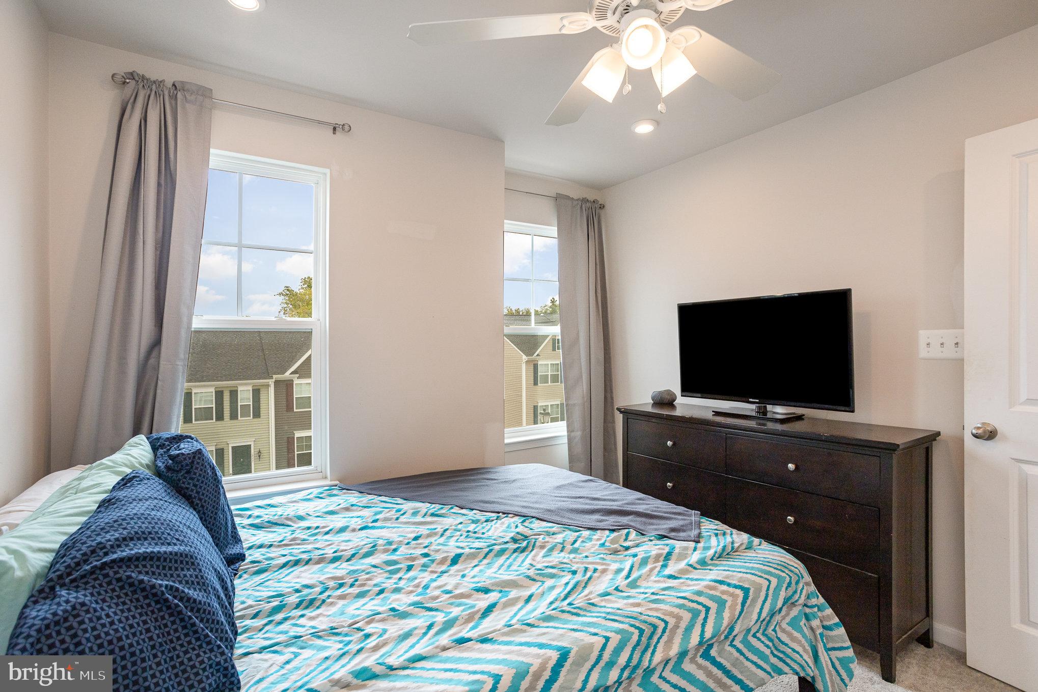 18236 Summit Pointe Drive Triangle, VA 22172 - Photo 28 of 36 a bedroom with a bed and a flat screen tv