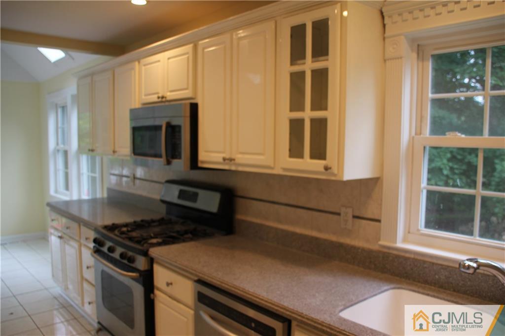 21 Channing Road East Brunswick, NJ 08816 - Photo 2 of 25 a kitchen with a stove and a microwave