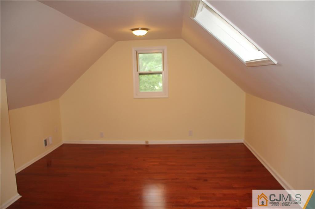 21 Channing Road East Brunswick, NJ 08816 - Photo 12 of 25 an empty room with wooden floor and windows