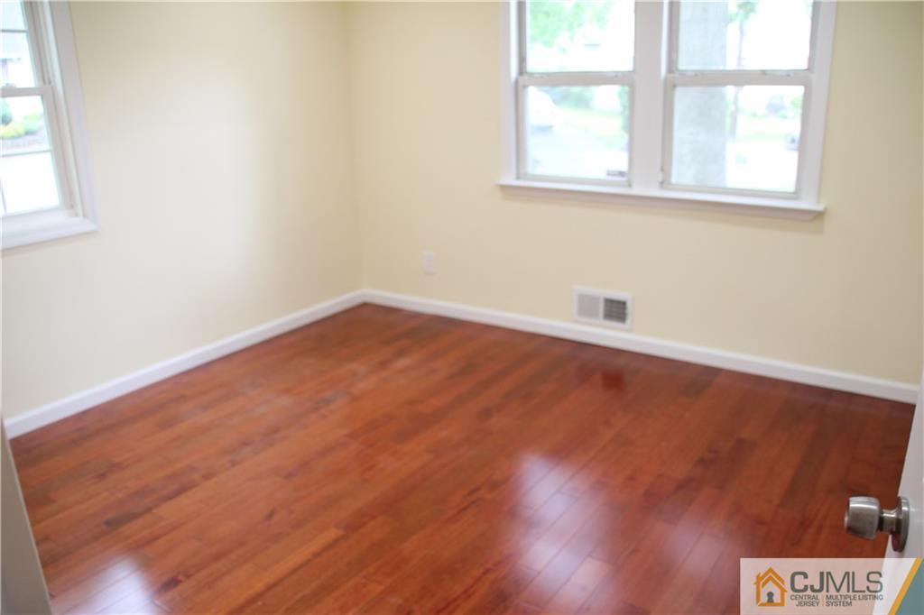21 Channing Road East Brunswick, NJ 08816 - Photo 16 of 25 an empty room with wooden floor and windows