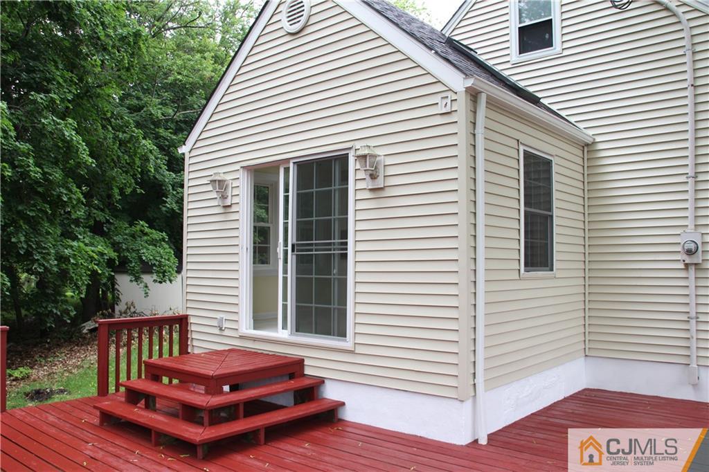 21 Channing Road East Brunswick, NJ 08816 - Photo 21 of 25 a backyard of a house with wooden floor chairs and a barbeque grill