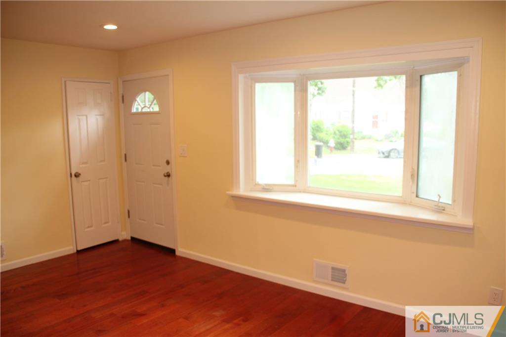 21 Channing Road East Brunswick, NJ 08816 - Photo 7 of 25 an empty room with wooden floor and windows