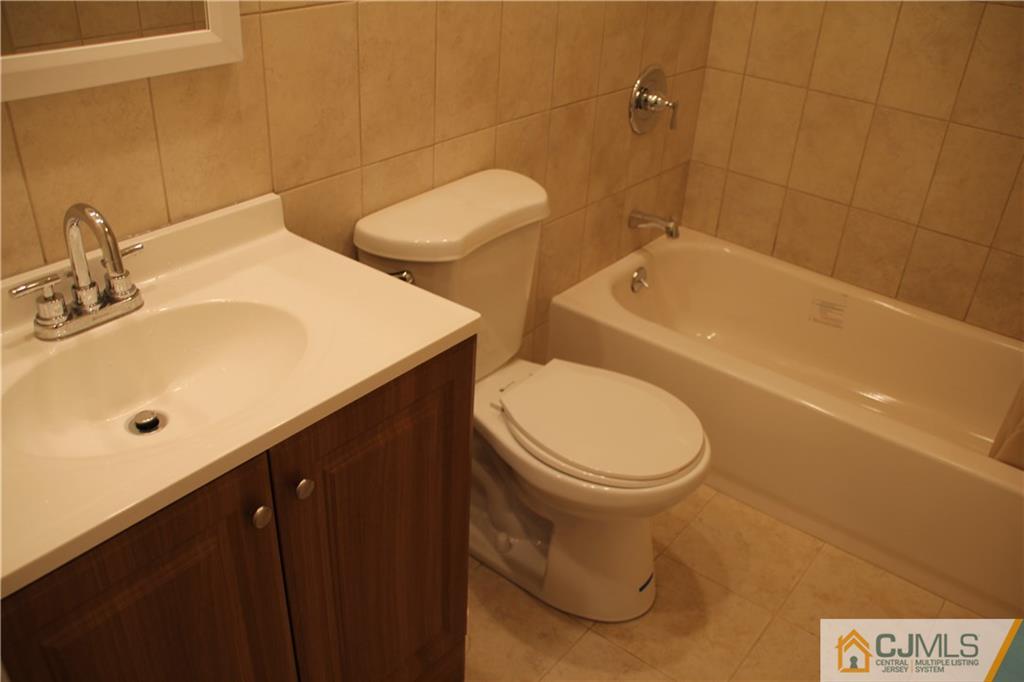 21 Channing Road East Brunswick, NJ 08816 - Photo 9 of 25 a bathroom with a sink a toilet and shower