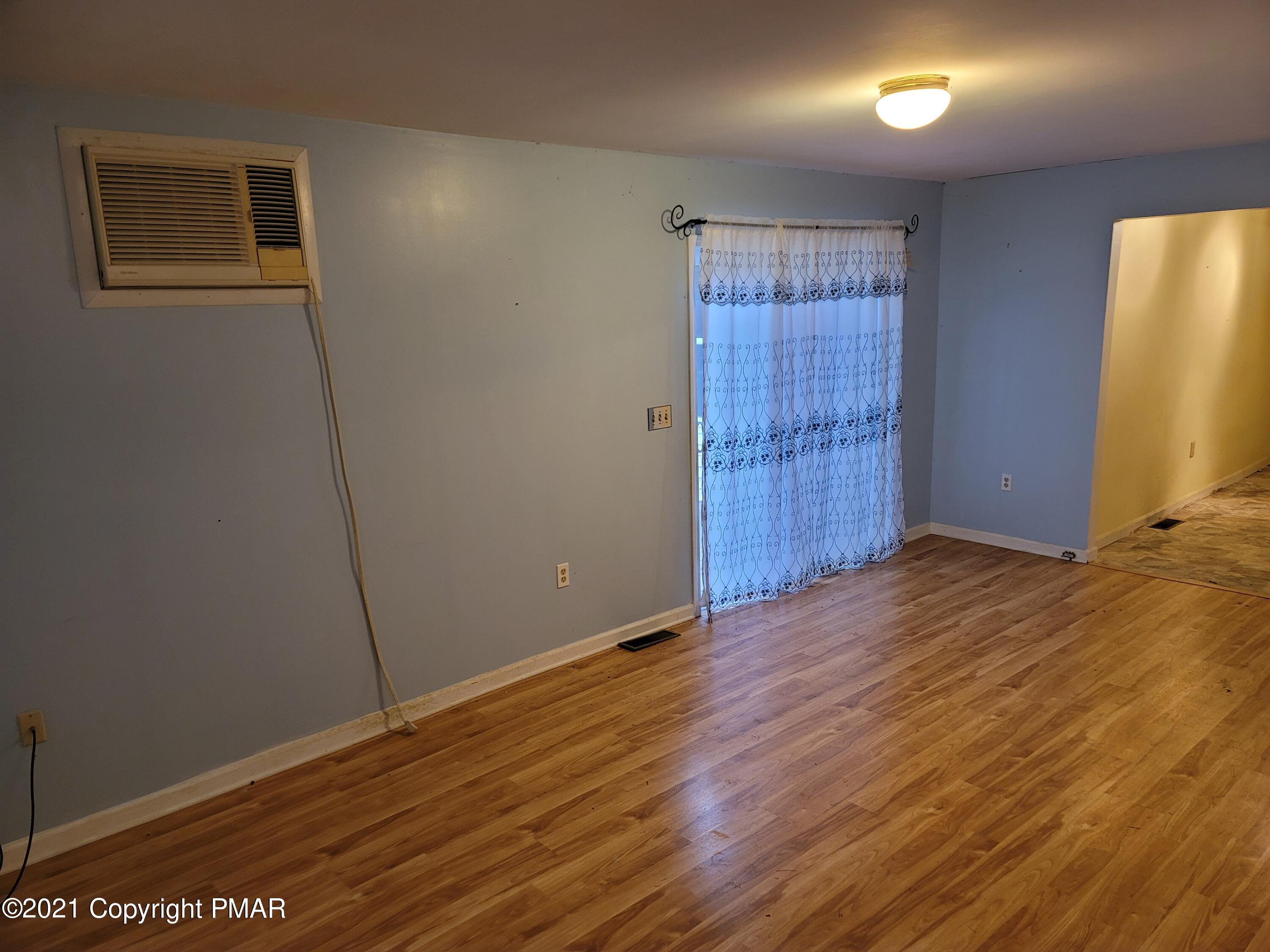 3388 Spruce Cabin Road Cresco, PA 18326 - Photo 8 of 33 a view of an empty room with wooden floor