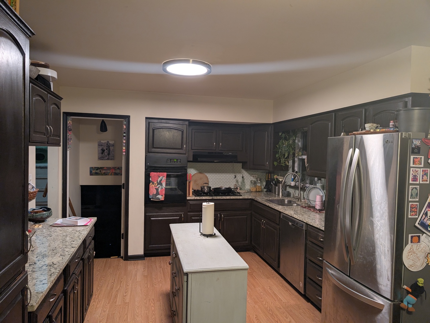 22W425 Arbor Lane Glen Ellyn, IL 60137 - Photo 10 of 18 a kitchen with stainless steel appliances kitchen island granite countertop a refrigerator a stove and a sink with wooden floor