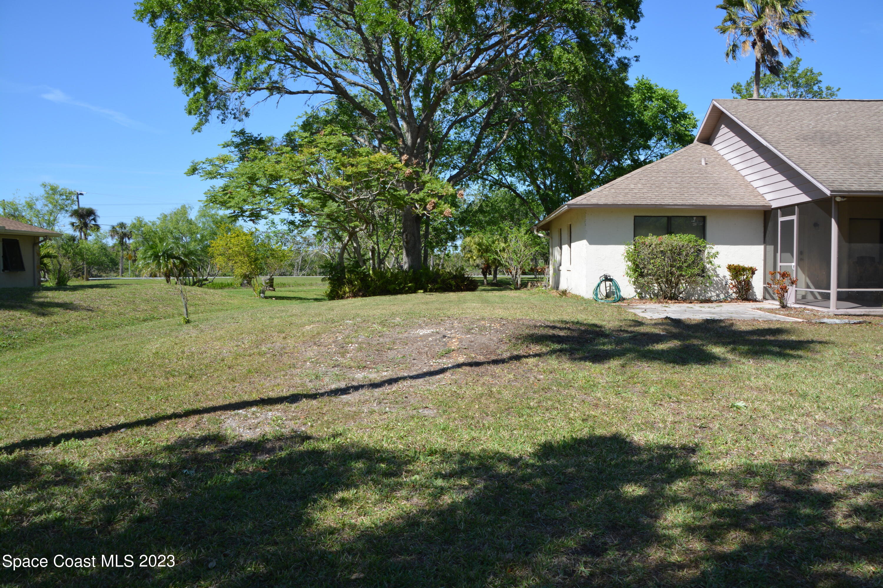 1045 Pine Island Road Merritt Island, FL 32953 - Photo 36 of 42 a front view of a house with a yard