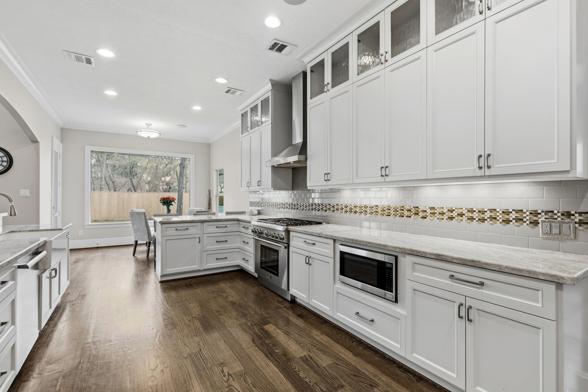 1938 Pech Road Houston, TX 77055 - Photo 12 of 39 a kitchen with stainless steel appliances granite countertop a stove and white cabinets