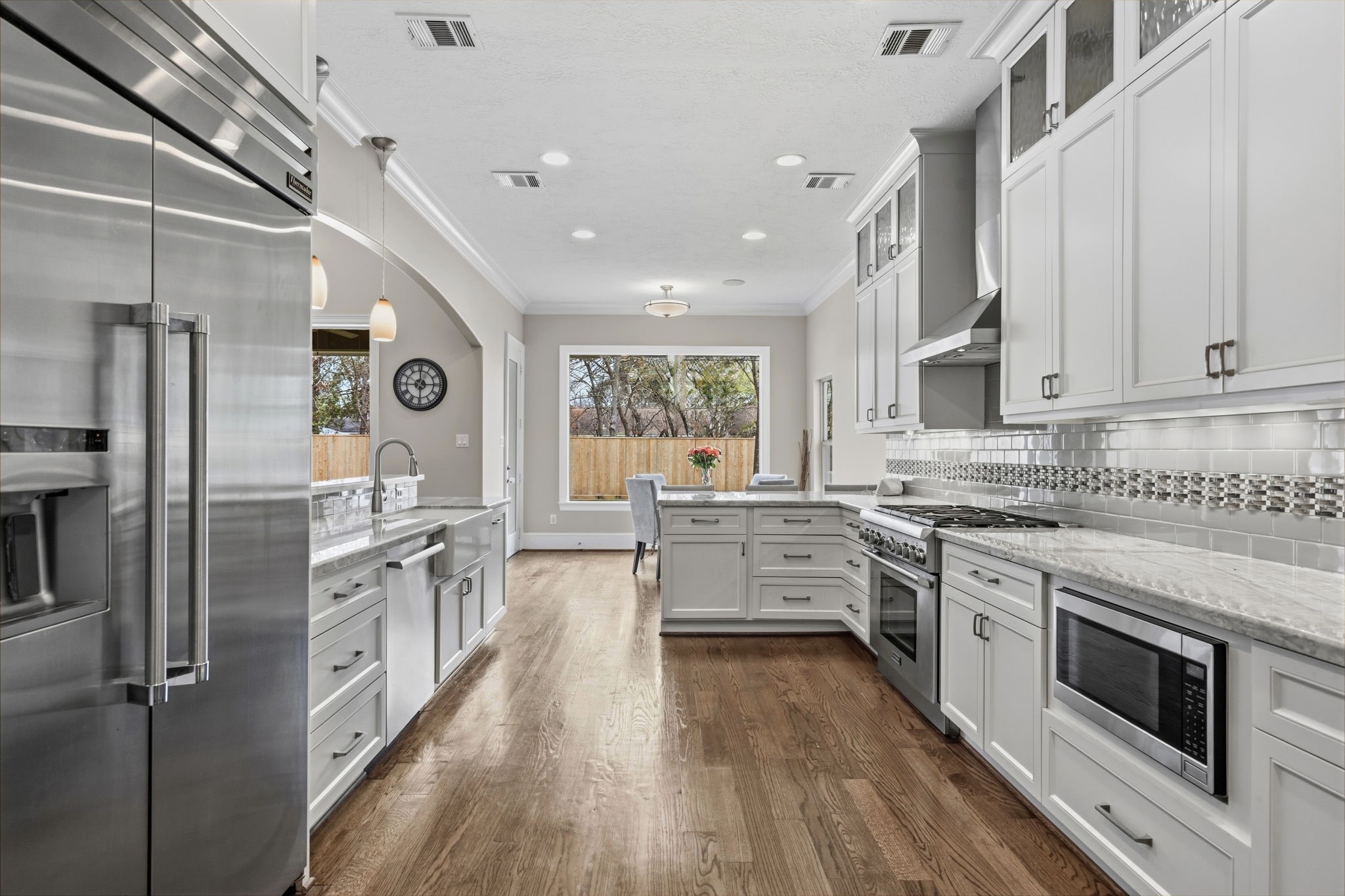 1938 Pech Road Houston, TX 77055 - Photo 13 of 39 a kitchen with stainless steel appliances granite countertop hardwood floor sink stove and refrigerator
