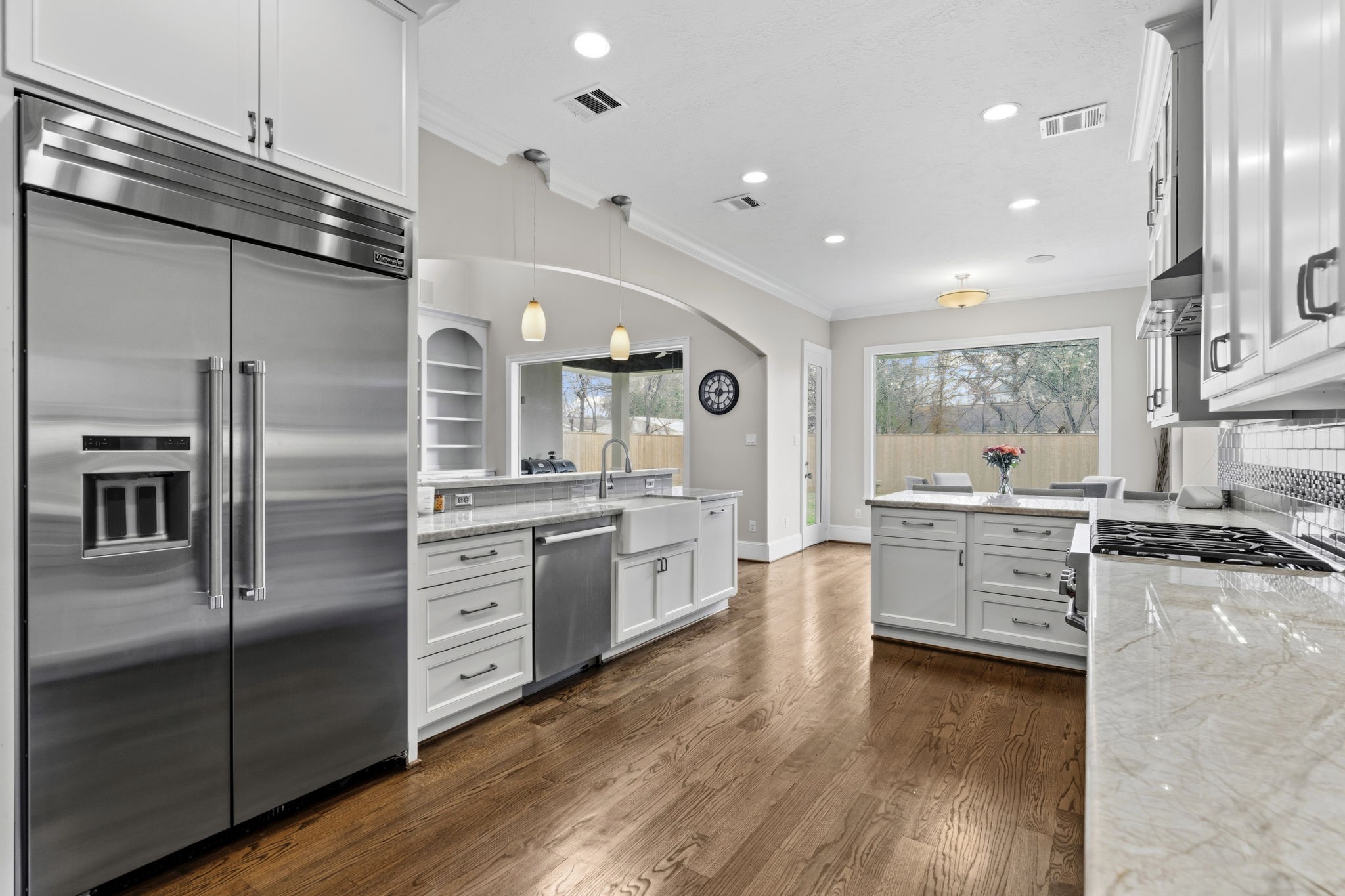 1938 Pech Road Houston, TX 77055 - Photo 14 of 39 a large kitchen with stainless steel appliances lots of counter top space and wooden floor
