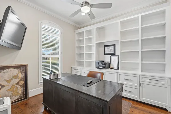 a view of a workspace with furniture and a window