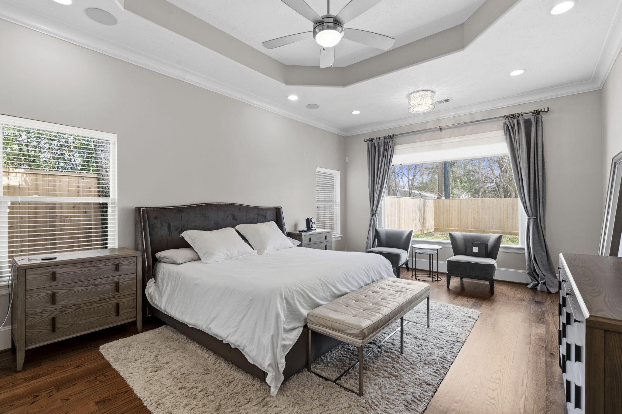 1938 Pech Road Houston, TX 77055 - Photo 21 of 39 a bedroom with a bed a chandelier and a dresser