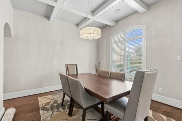 a view of a dining room with furniture wooden floor and chandelier