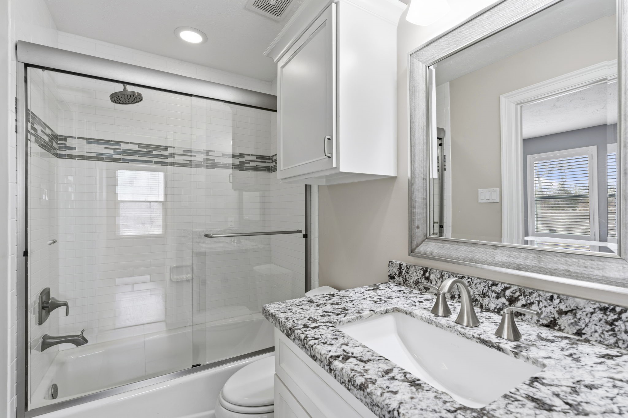 1938 Pech Road Houston, TX 77055 - Photo 31 of 39 a bathroom with a granite countertop sink a mirror and shower