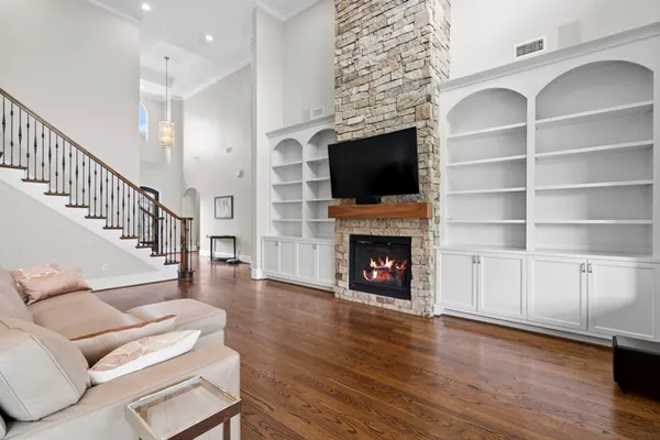 a living room with furniture a flat screen tv and a fireplace