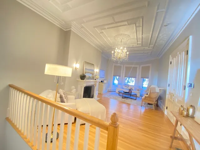 a living room with furniture and a chandelier