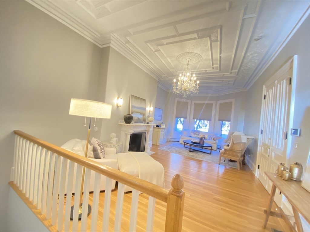 214 Commonwealth Avenue, Unit 1 Boston, MA 02116 - Photo 14 of 22 a living room with furniture and a chandelier
