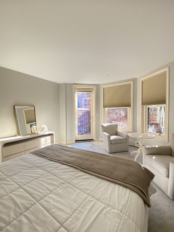 214 Commonwealth Avenue, Unit 1 Boston, MA 02116 - Photo 15 of 22 a spacious bedroom with a bed and glass walk in closet