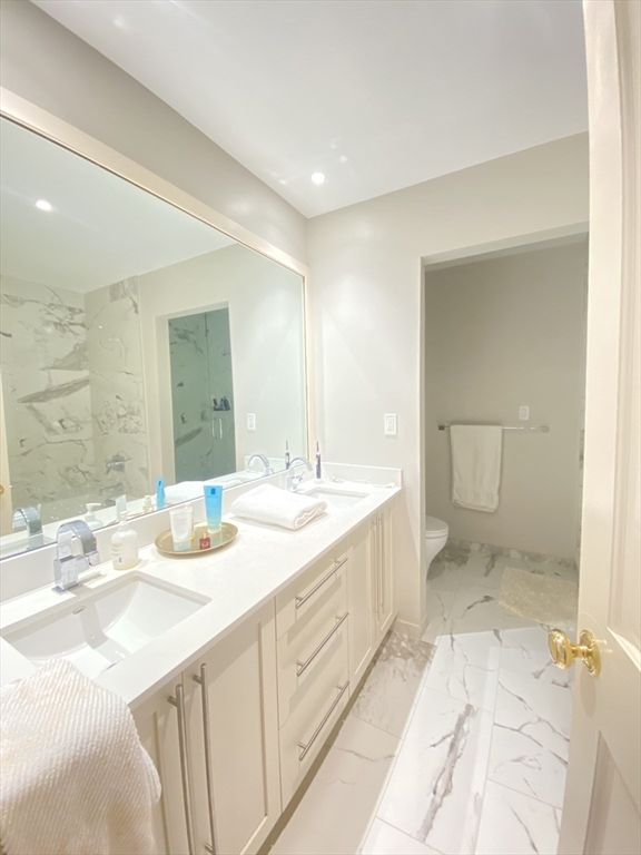 214 Commonwealth Avenue, Unit 1 Boston, MA 02116 - Photo 17 of 22 a bathroom with a sink double vanity and a mirror