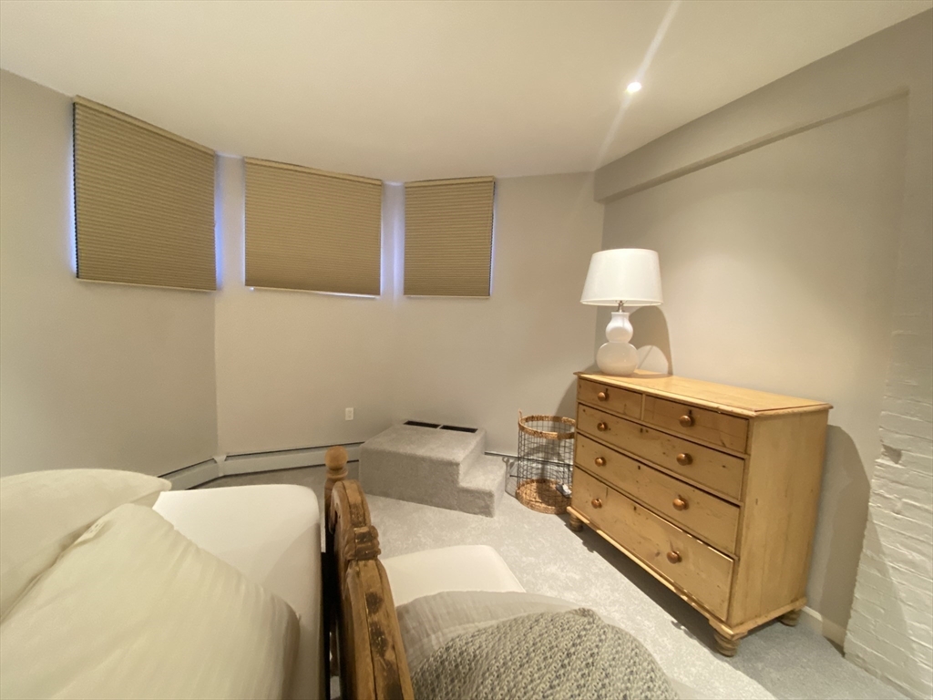 214 Commonwealth Avenue, Unit 1 Boston, MA 02116 - Photo 19 of 22 a bed room with a bed and a lamp