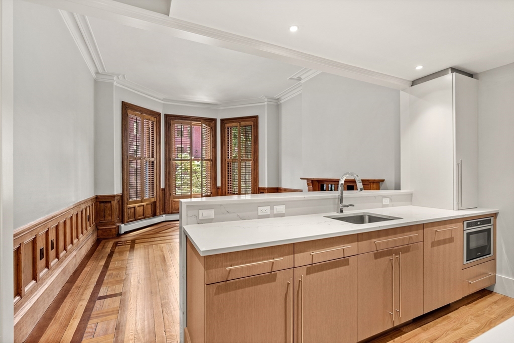 214 Commonwealth Avenue, Unit 1 Boston, MA 02116 - Photo 2 of 22 a kitchen with a sink and a window