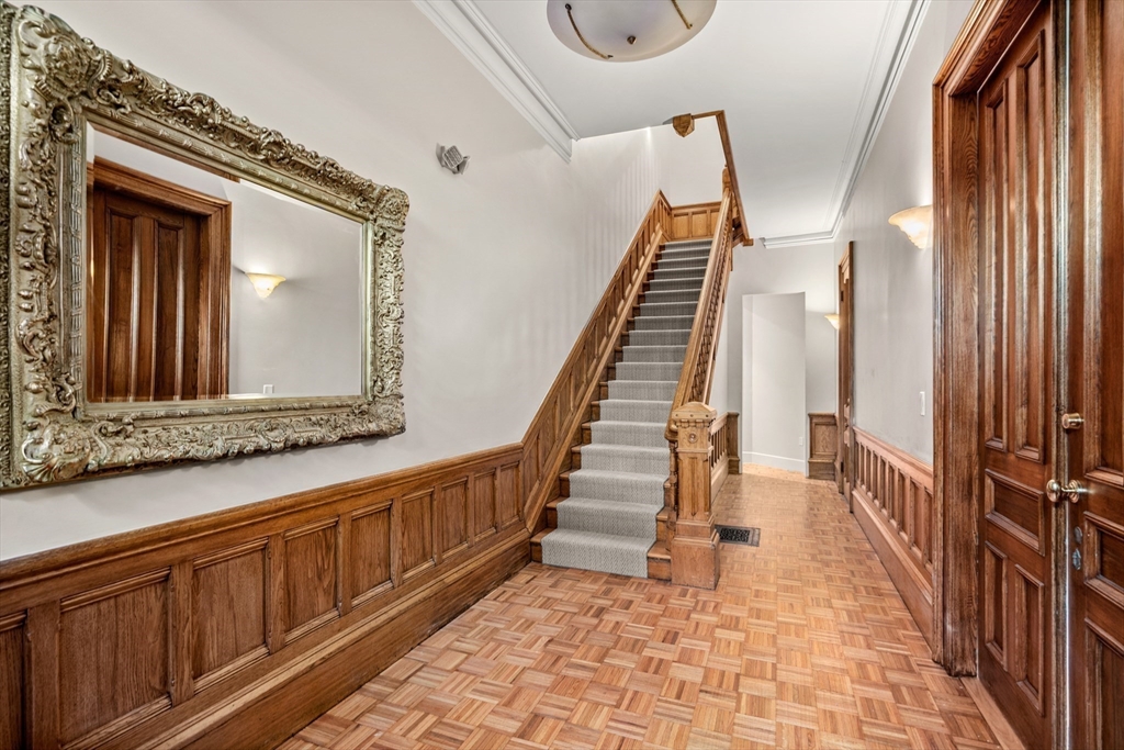 214 Commonwealth Avenue, Unit 1 Boston, MA 02116 - Photo 21 of 22 a view of a hallway with wooden floor and staircase