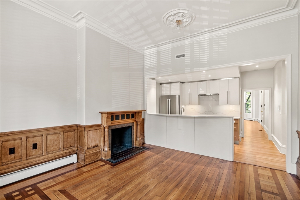 214 Commonwealth Avenue, Unit 1 Boston, MA 02116 - Photo 3 of 22 a kitchen with stainless steel appliances a stove top oven and a refrigerator