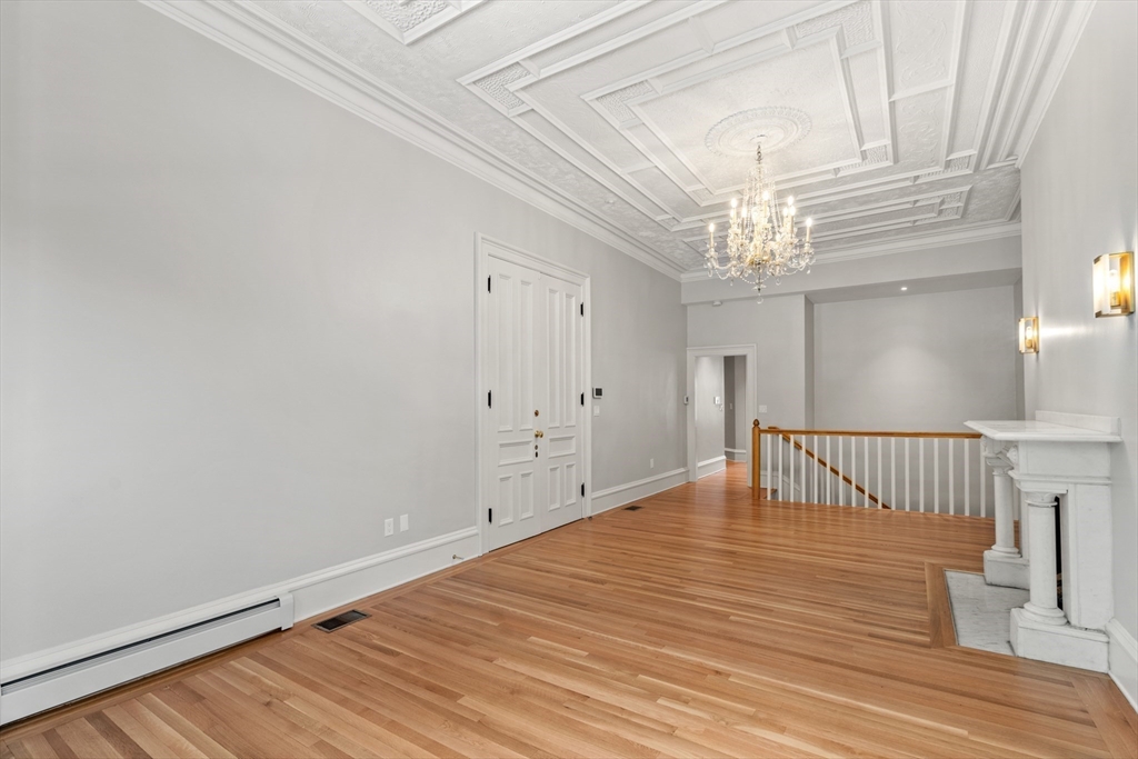 214 Commonwealth Avenue, Unit 1 Boston, MA 02116 - Photo 4 of 22 a view of an empty room with wooden floor
