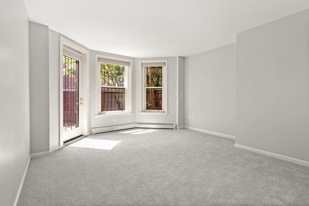 214 Commonwealth Avenue, Unit 1 Boston, MA 02116 - Photo 5 of 22 a view of an empty room with a window