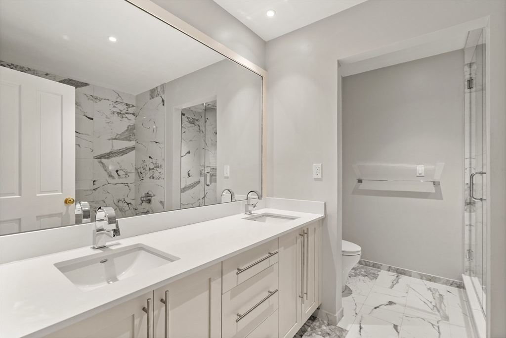 214 Commonwealth Avenue, Unit 1 Boston, MA 02116 - Photo 6 of 22 a bathroom with a sink a toilet and shower
