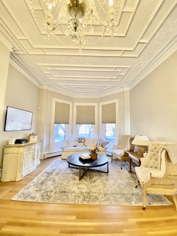 214 Commonwealth Avenue, Unit 1 Boston, MA 02116 - Photo 8 of 22 a living room with fireplace furniture and a potted plant
