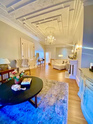 a living room with furniture and a chandelier
