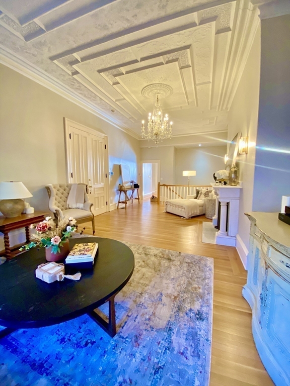 214 Commonwealth Avenue, Unit 1 Boston, MA 02116 - Photo 9 of 22 a living room with furniture and a chandelier