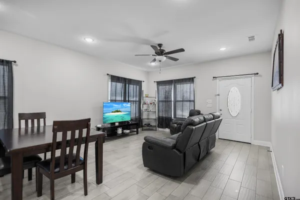 a living room with furniture and a wooden floor