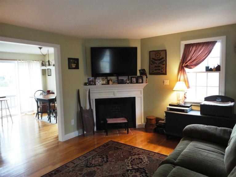 7 Park Road Mashpee, MA 02649 - Photo 2 of 9 a living room with furniture a flat screen tv and a fireplace