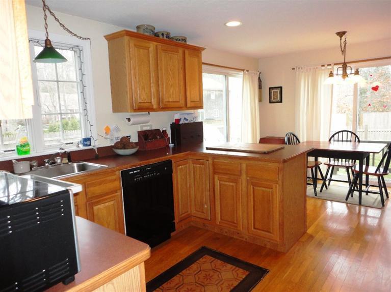 7 Park Road Mashpee, MA 02649 - Photo 3 of 9 a kitchen with granite countertop a sink dishwasher stove and cabinets