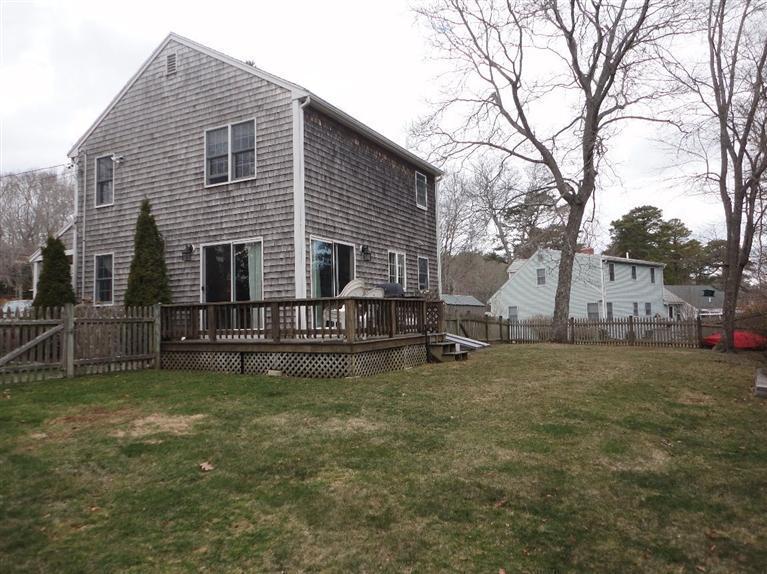 7 Park Road Mashpee, MA 02649 - Photo 6 of 9 a view of a house with a yard and a wooden fence