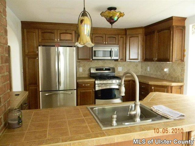 7 Cedar Street Rifton, NY 12471 - Photo 3 of 9 a kitchen with a sink a refrigerator and cabinets