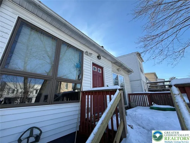 a balcony view with wooden floor and outdoor seating