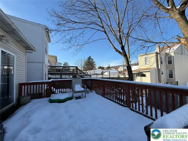 a view of a street with wooden fence