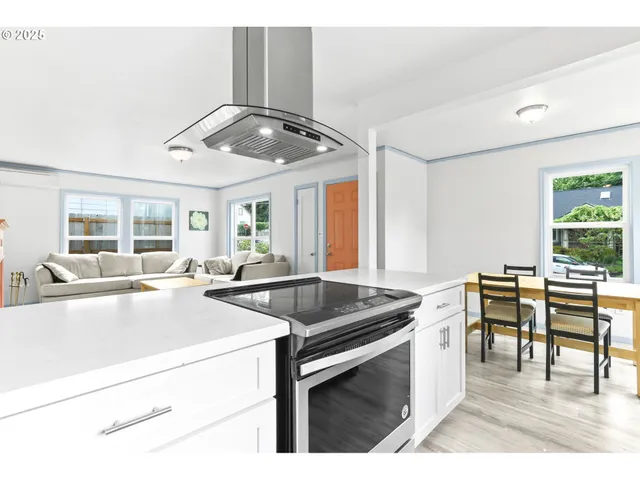 a kitchen with stainless steel appliances granite countertop a sink and stove