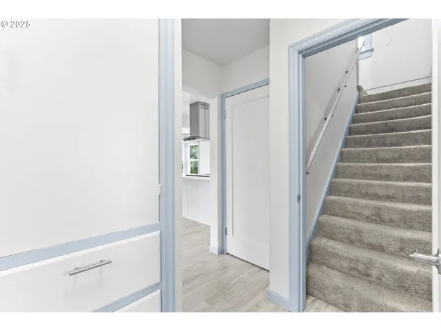 a view of an entryway with wooden floor