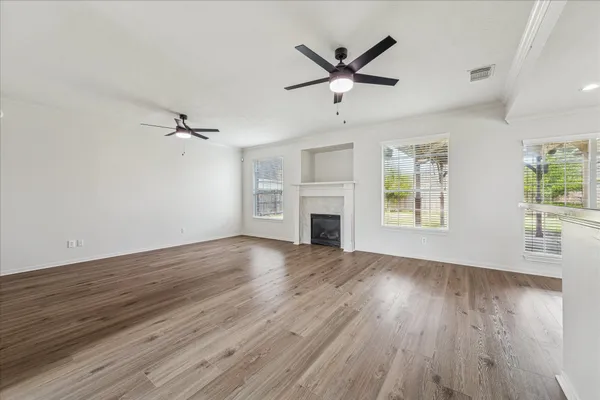 wooden floor in an empty room with a window
