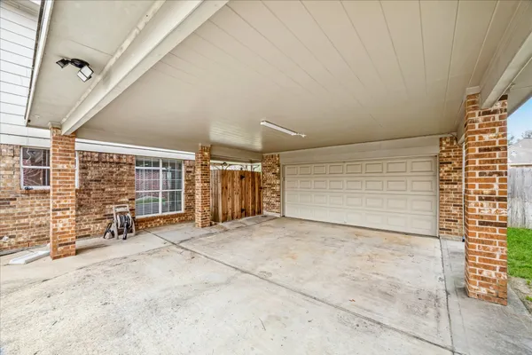 a view of an empty room with a brick wall