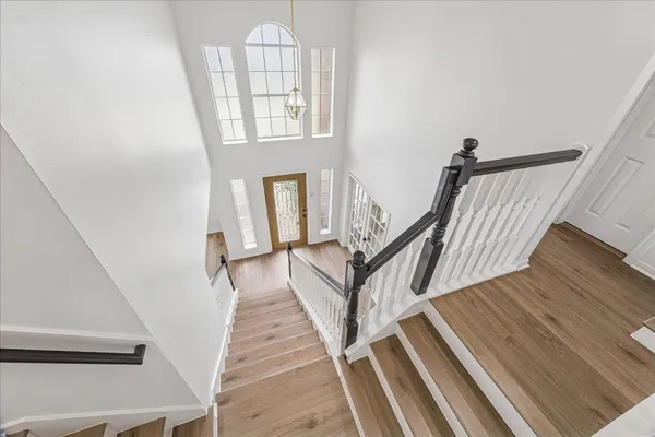 a view of staircase with railing and white walls