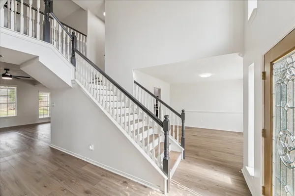 a view of staircase with white walls and a window