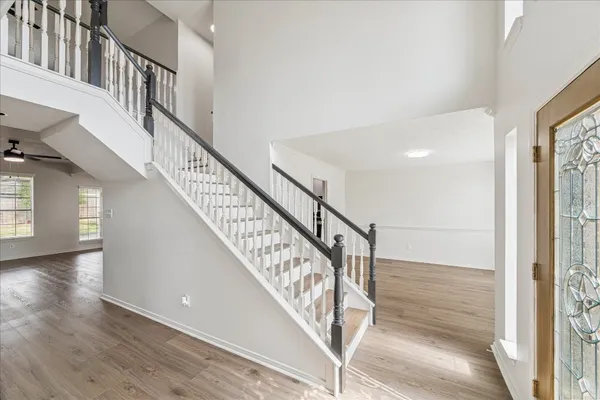 a view of staircase with white walls and a window