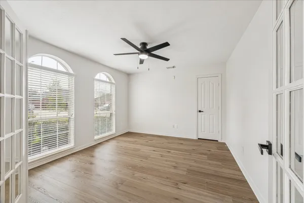 wooden floor in an empty room with a window