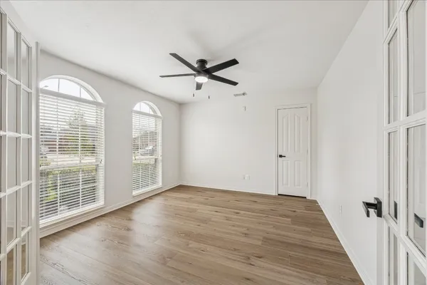 wooden floor in an empty room with a window