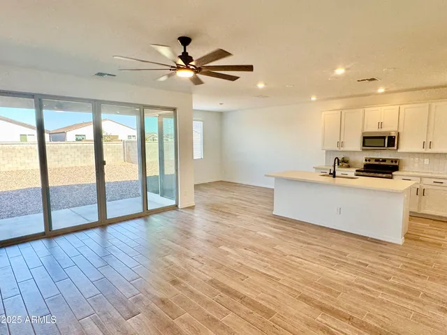 a view of kitchen with wooden floor electronic appliances and window